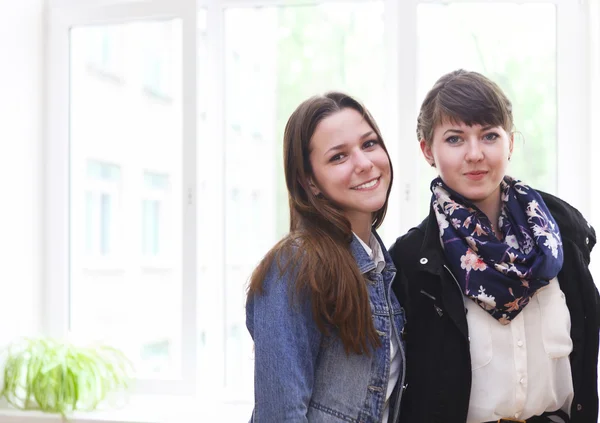 Two female students near the window in classroom — Stock Photo, Image