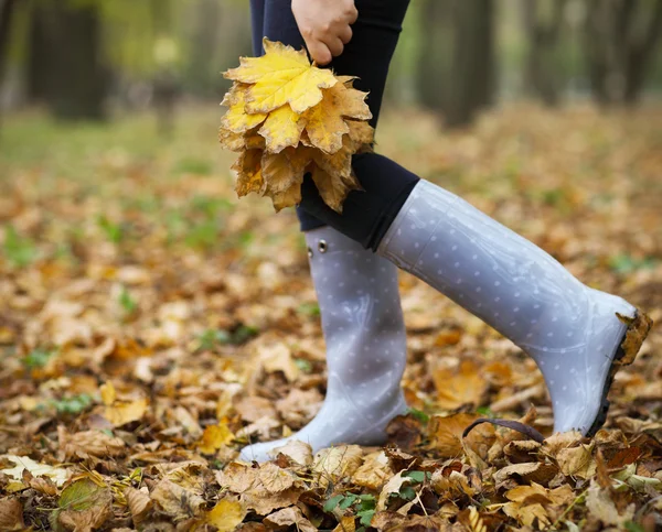 Frau hat Spaß mit gelben Ahornblättern — Stockfoto