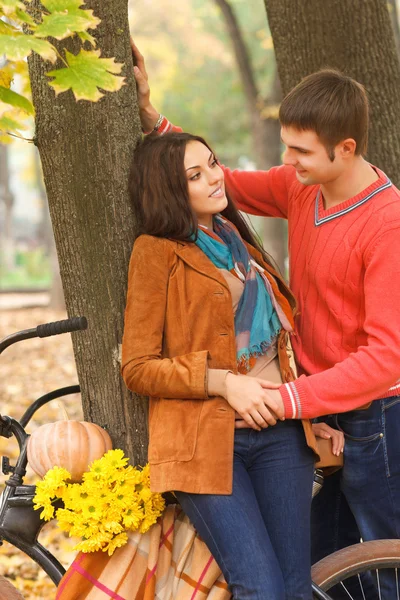 Coppia con bicicletta nel parco autunnale — Foto Stock