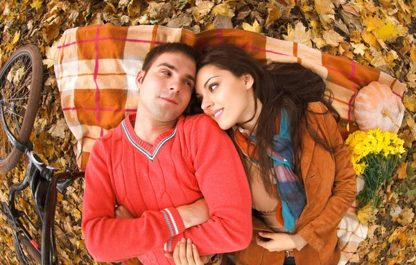 Couple with bicycle in autumn park — Stock Photo, Image