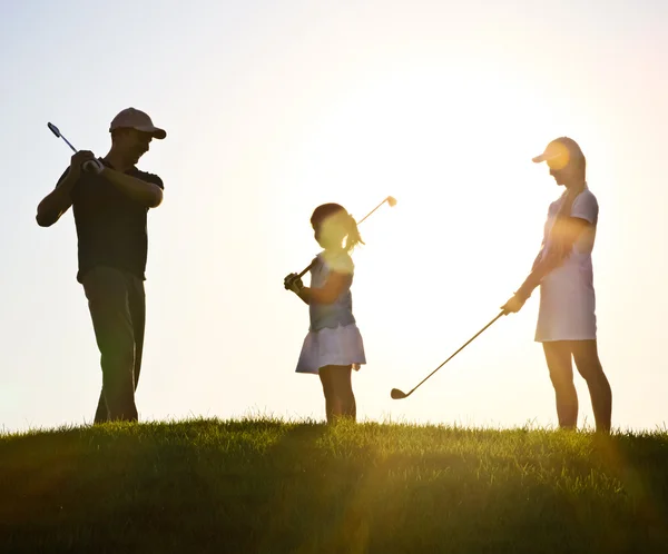 Family of a golfers at sunset — Stock Photo, Image