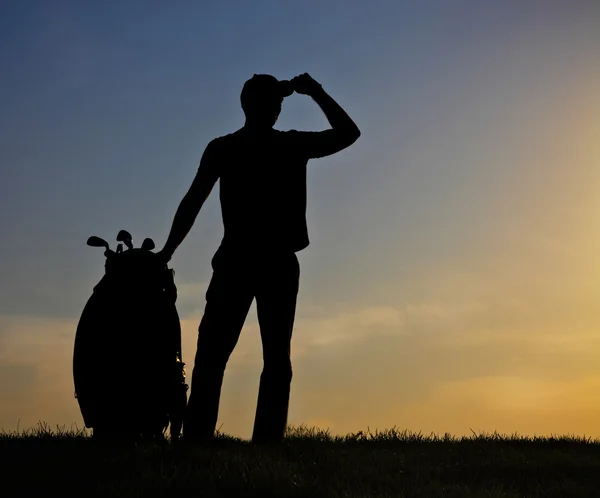 Mužské golfista při západu slunce — Stock fotografie