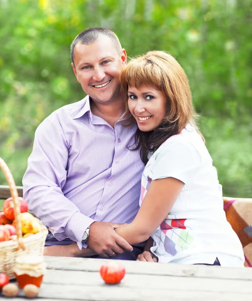 Happy smiling couple in the autumn forest on the picnic — Stock Photo, Image