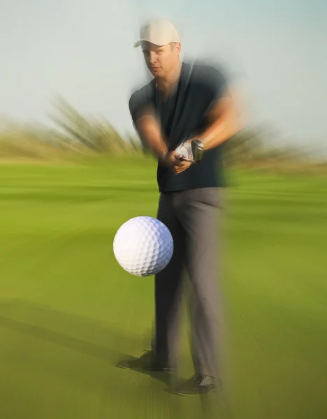 Golf ball just coming off a golfer in swing — Stock Photo, Image