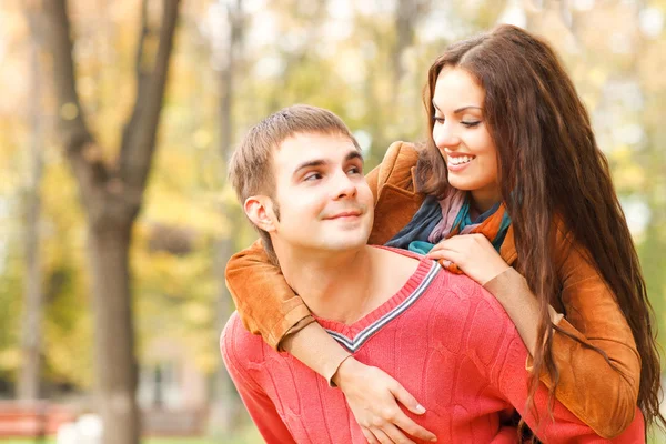 Portrait of couple enjoying golden autumn fall season — Stock Photo, Image