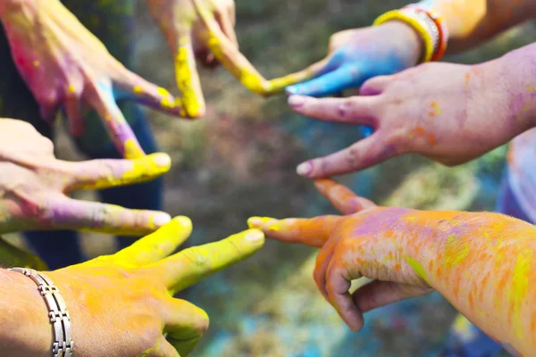 Friends putting their hands together in a sign of unity and team