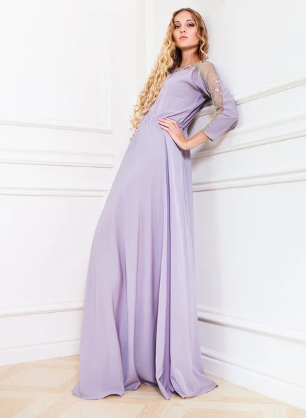 Beautiful blond woman in long lavender dress — Stock Photo, Image