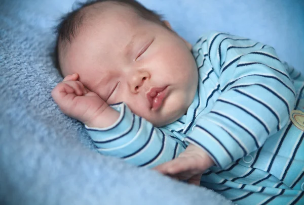 Peaceful baby lying on a bed while sleeping — Stock Photo, Image