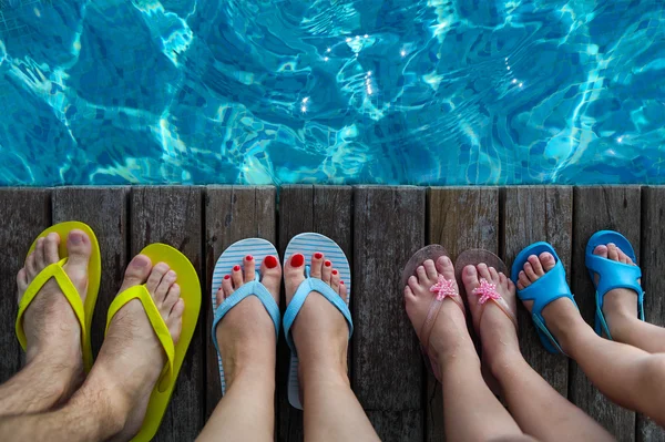 Family wearing brightly colored flip-flops — Stock Photo, Image