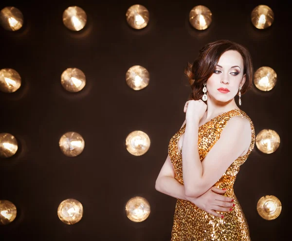 Superstar woman wearing golden shining dress — Stock Photo, Image