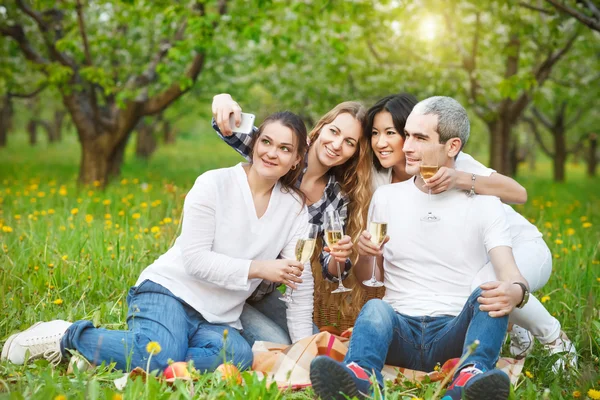 Happy friends taking selfie with camera or smartphone — Stock Photo, Image