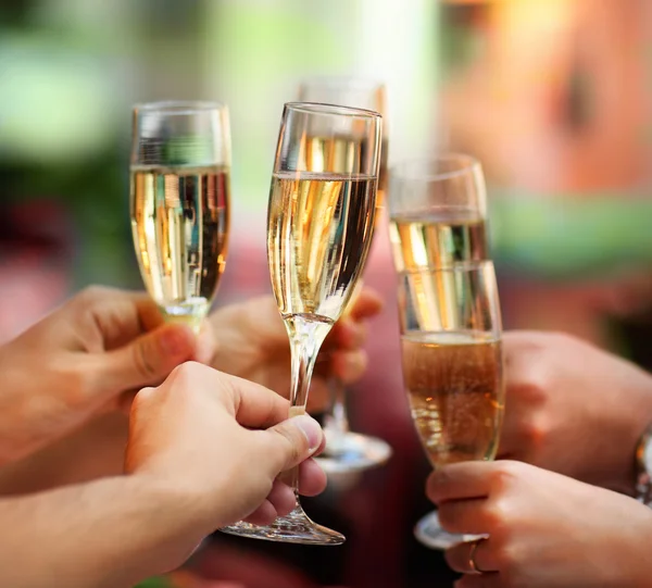 Gente sosteniendo copas de champán haciendo un brindis — Foto de Stock