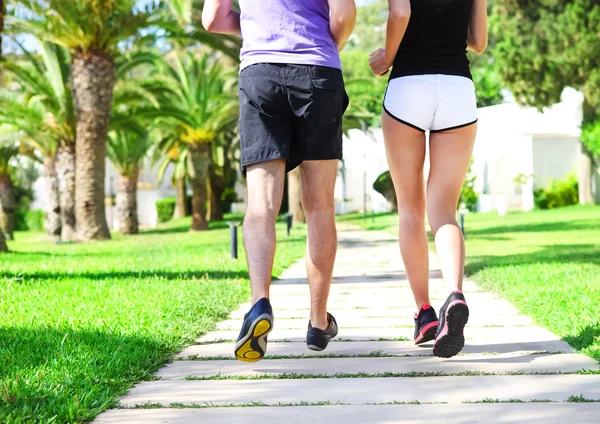Rear view of caucasian female and male runners — Stock Photo, Image