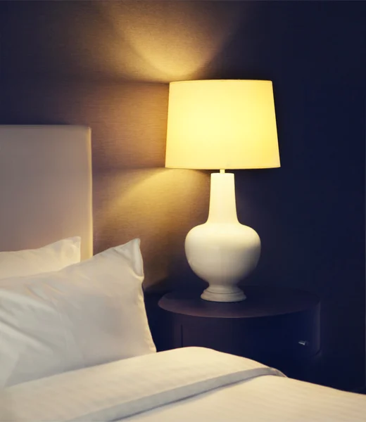 Hotel bedroom with lamp and hotel bed with space for text — Stock Photo, Image