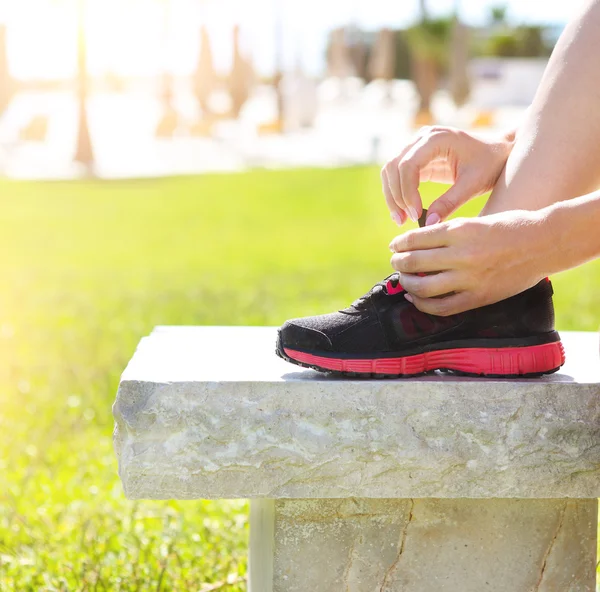 Athlete girl trying running shoes getting ready for jogging — Stock Photo, Image