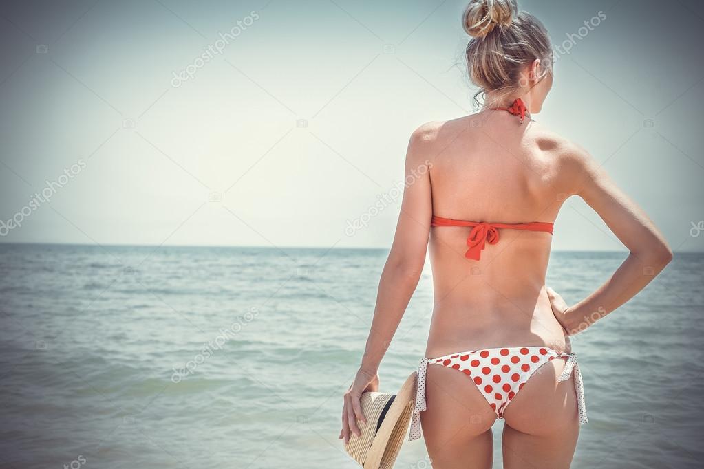 Beautiful young woman in sexy bikini at the beach