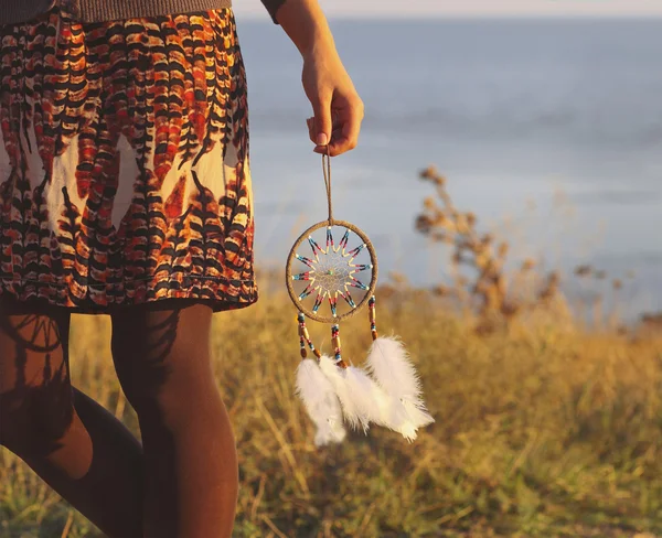 Brunette woman with long hair holding dream catcher — Stock Photo, Image