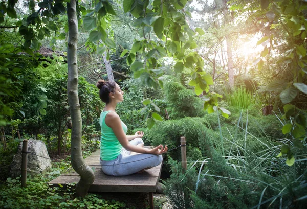 Jovem mulher fazendo ioga asana à noite — Fotografia de Stock