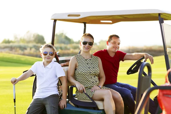 Retrato familiar en un carrito en el campo de golf — Foto de Stock