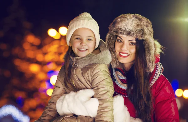 Happy mother and little daughter playing in the winter Christmas — Stock Photo, Image