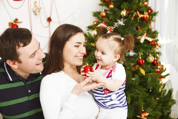 Happy family with Christmas baby near the Christmas tree — Stock Photo, Image