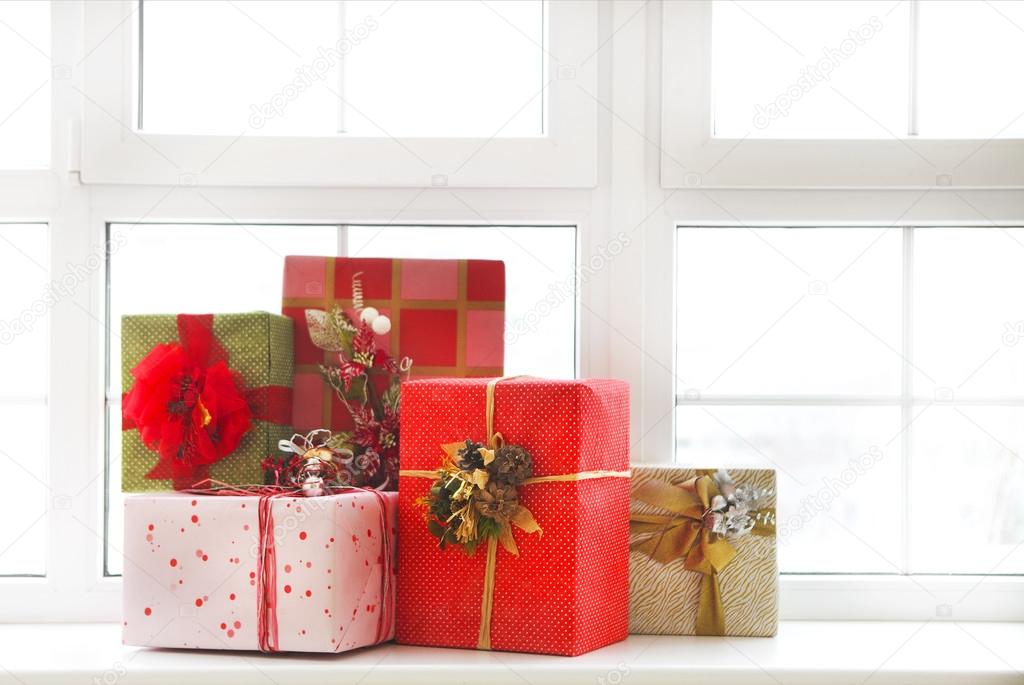 Beautiful bright Christmas gifts on windowsill