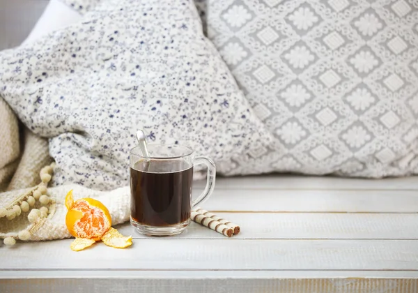 Cozy still life with black coffee and tangerine — Stock Photo, Image