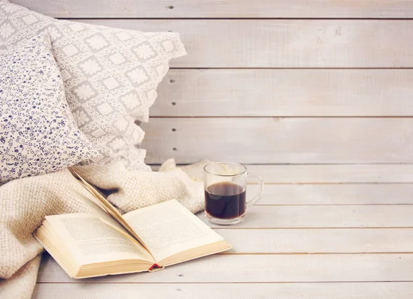 Cozy still life with book, coffee, pillows and plaid — Stock Photo, Image