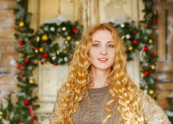 Happy young woman by the Christmas decorations — Stock Photo, Image