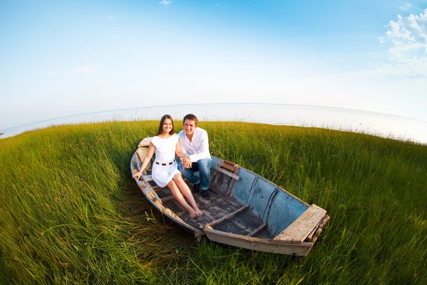 Young happy couple in love in a boat — Stock Photo, Image
