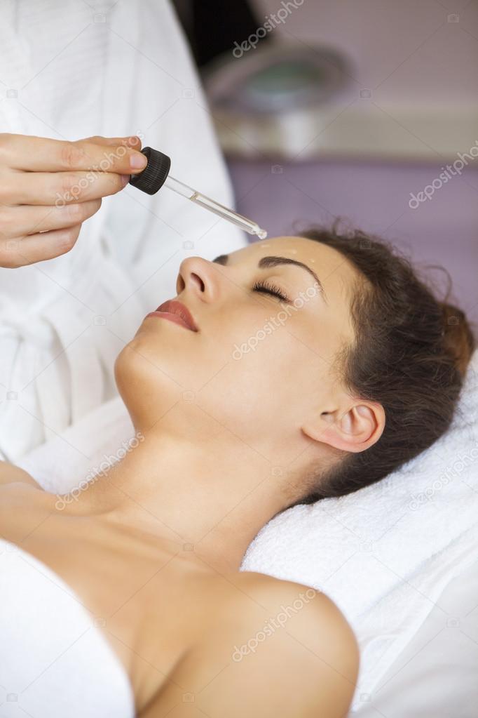 Close up portrait of a young woman getting spa treatment