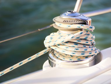 Sailboat detailed parts. Close up on winch and rope of yacht ove clipart