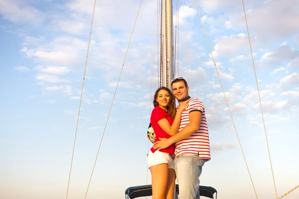 Young smiling couple on a sailing boat at summer — Stock Photo, Image