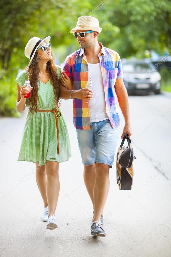 Happy couple walking with guitar