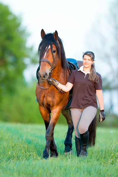 Donna e cavallo che camminano nel campo — Foto Stock