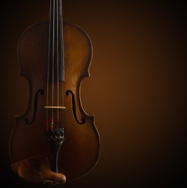 old wooden violin on dark brown background clipart