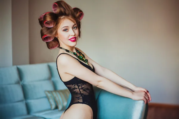 Beauty portrait of young woman wearing curlers — Stock Photo, Image