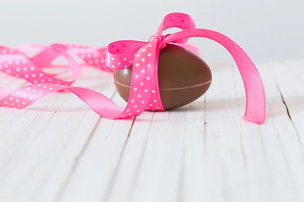 Chocolate Easter egg on wooden background — Stock Photo, Image