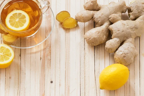 Cup of ginger tea on a wooden table — Stock Photo, Image