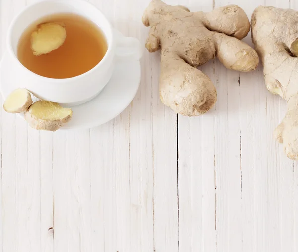 Ginger tea in a white cup on wooden background — Stock Photo, Image