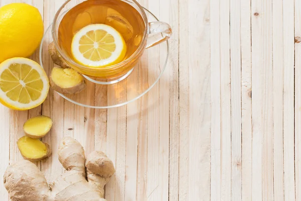 Cup of ginger tea on a wooden table — Stock Photo, Image