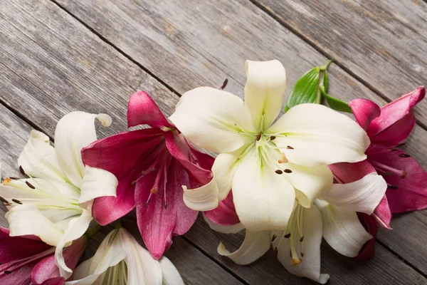 Lily on wooden background — Stock Photo, Image