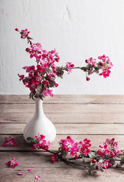pink flowers in vase on wooden table