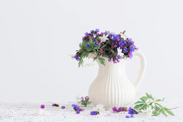 Bouquet of spring flowers in a jug — Stock Photo, Image