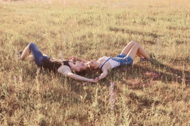 Genç çift rahatlatıcı bir yaz Park'ın bahçesinde