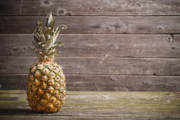 Pineapple on wooden table — Stock Photo, Image