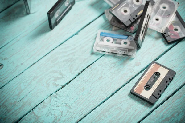 Audio tapes on blue wooden background — Stock Photo, Image