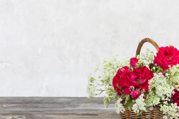 Flowers in basket on old background — Stock Photo, Image