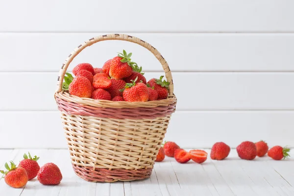 Frische Erdbeeren im Korb auf weißem Holzhintergrund — Stockfoto