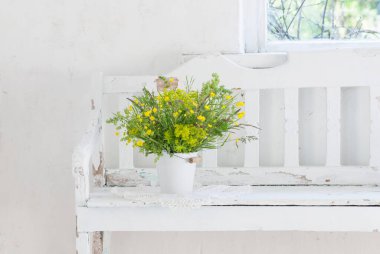 # Kovadaki çiçekler # # Beyaz ahşap bankta #